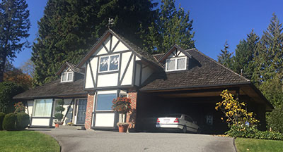 Tudor-style detached house with a carport, typical of a pre-purchase home inspection in Metro Vancouver